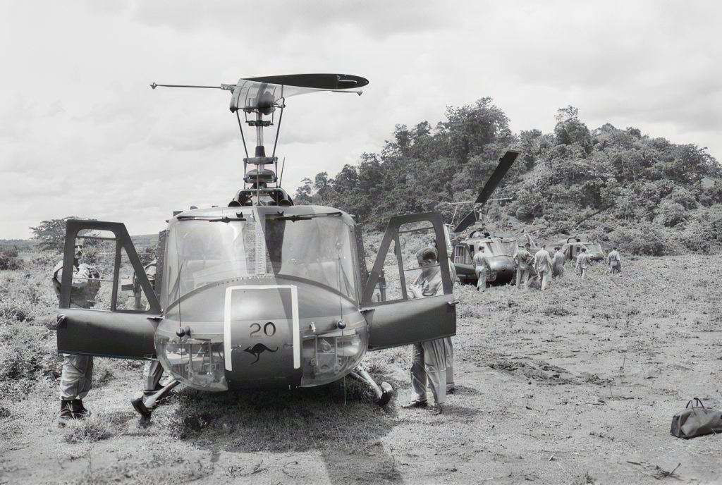 A2-1020 and other Iroquois helicopters of No 9 Squadron, RAAF, sitting on the helicopter pad at the Task Force Headquarters